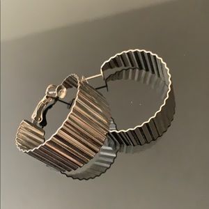 Silver colored metal textured hoop earrings